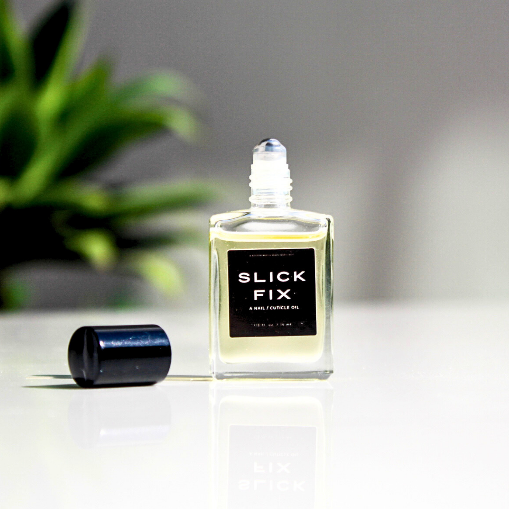 SLICK FIX, A NAIL / CUTICLE OIL Predominantly Black