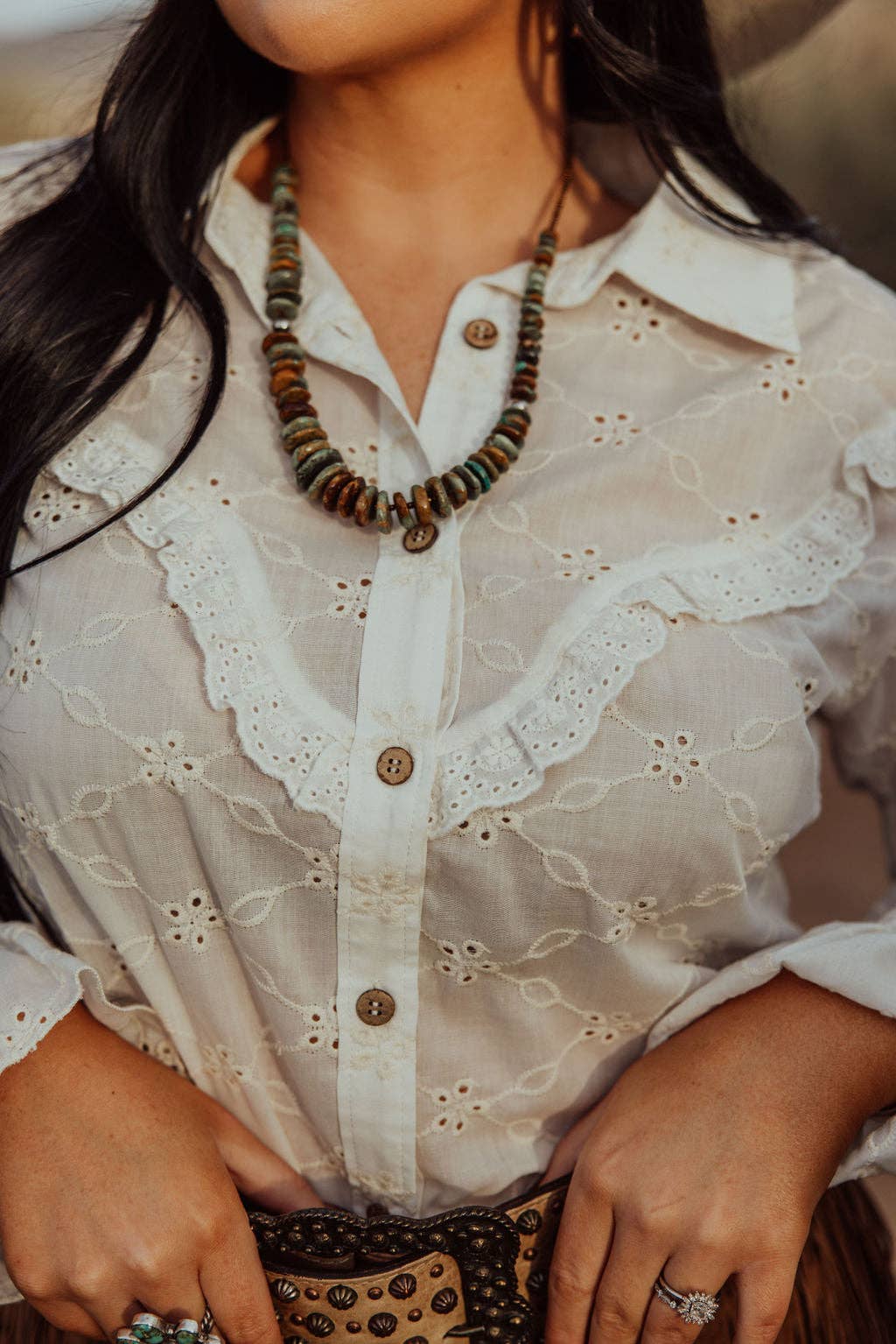Turquoise Haven "Prairie Eyelet" Western Ruffle Blouse — Ivory Eyelet with Wooden Buttons & Flared Cuff Hem (small remains) Cowhide and Conchos