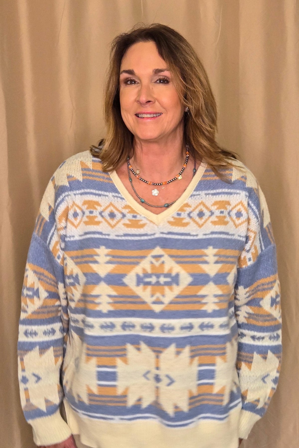 Main Strip Southwestern Knit Sweater — Oversized V-Neck with Bold Blue, Tan & Cream Print Cowhide and Conchos