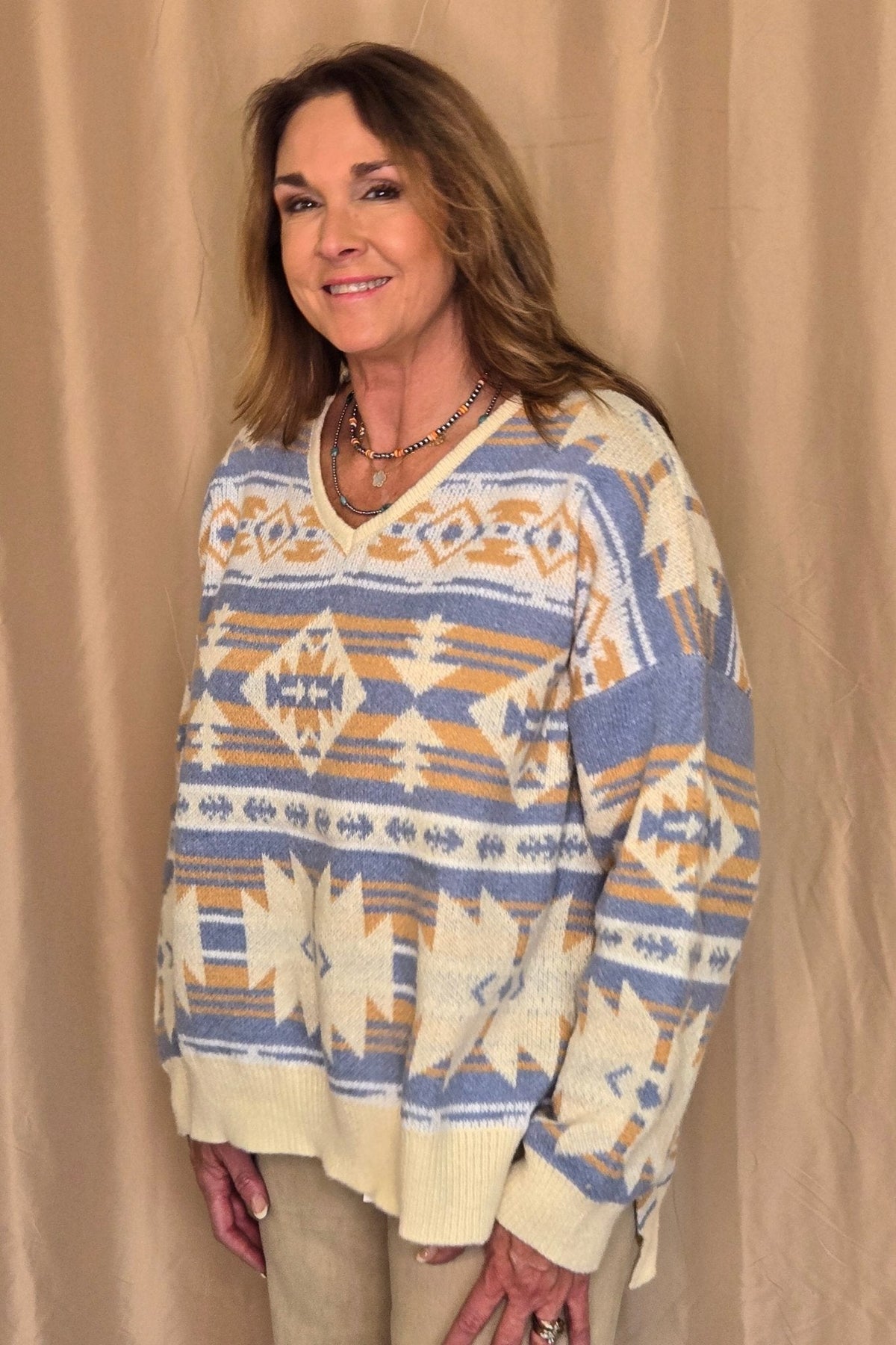 Main Strip Southwestern Knit Sweater — Oversized V-Neck with Bold Blue, Tan & Cream Print Cowhide and Conchos