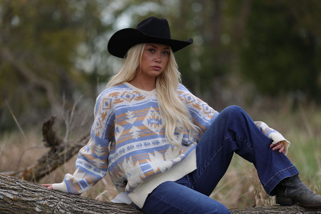 Main Strip Southwestern Knit Sweater — Oversized V-Neck with Bold Blue, Tan & Cream Print Cowhide and Conchos