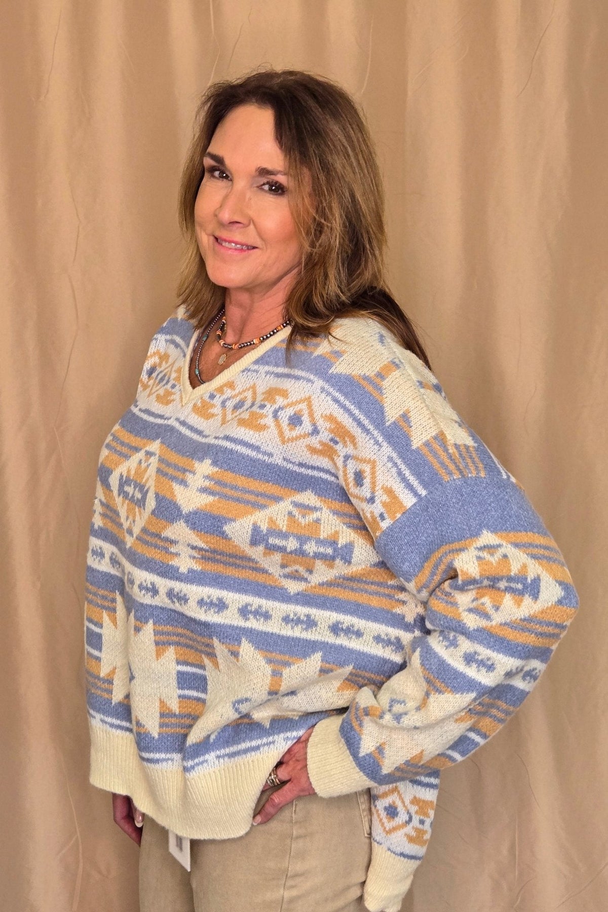 Main Strip Southwestern Knit Sweater — Oversized V-Neck with Bold Blue, Tan & Cream Print Cowhide and Conchos