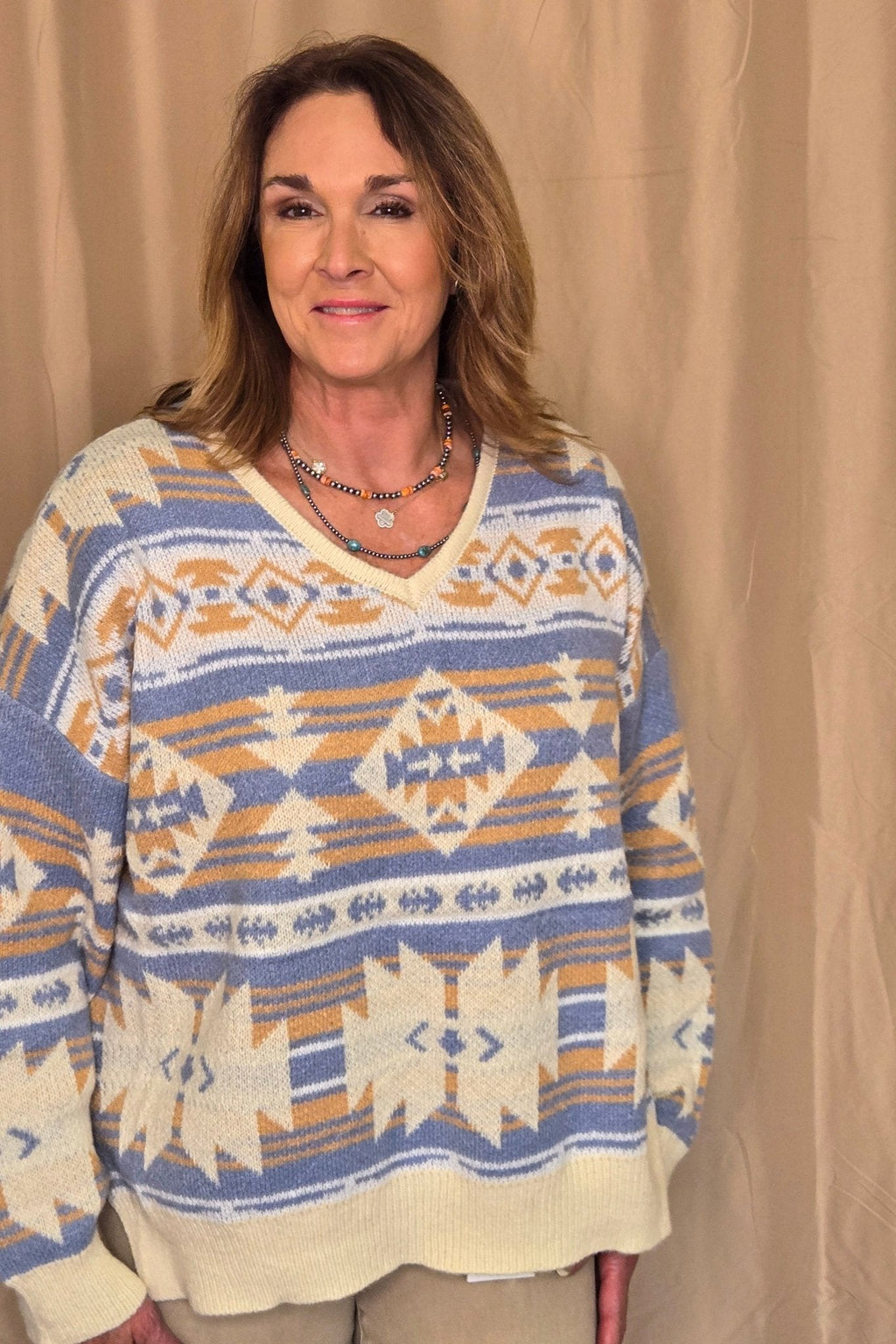 Main Strip Southwestern Knit Sweater — Oversized V-Neck with Bold Blue, Tan & Cream Print Cowhide and Conchos
